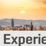 A stunning sunset view of the Barcelona skyline showcasing iconic landmarks and a warm, golden hour glow.